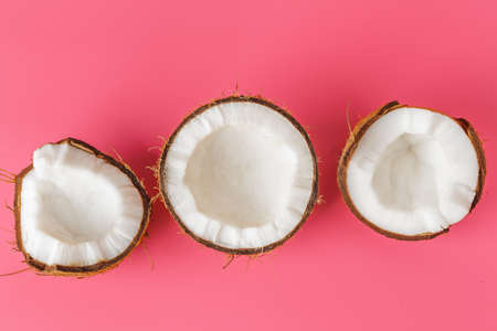 Coconut halves on a bright pink backgroundの写真素材