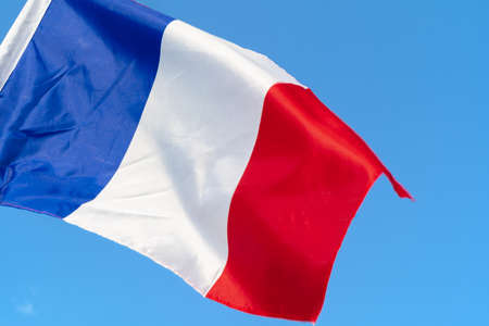 Flag of France waving in the wind in the skyの写真素材
