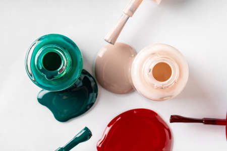 Several opened bottles of nail polish on white backgroundの写真素材