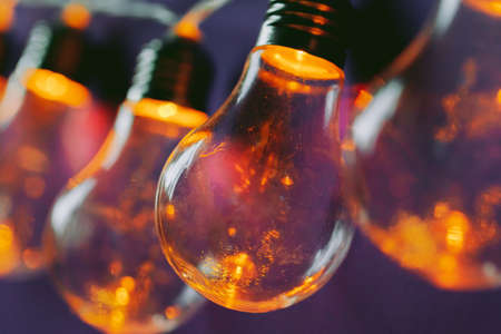 Beautiful illuminated festive light bulbs garland close upの写真素材