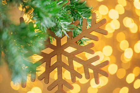 Christmas tree background and Christmas decoration with snowflake on golden bokeh backgroundの写真素材