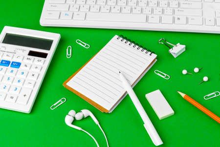 Green office desk with white stationery, copy spaceの写真素材