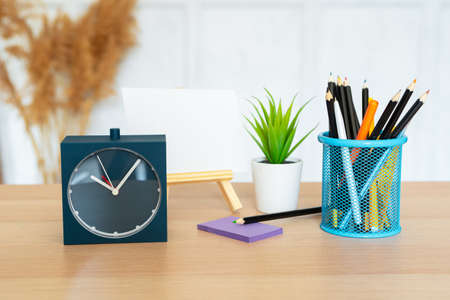 Office interior details with alarm clock and stationery itemsの写真素材