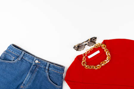 Woman outfit with red sweater and accessories on whiteの写真素材