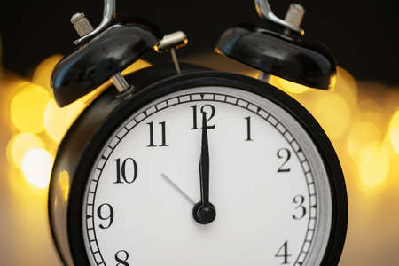 Close up of retro alarm clock on blurred Christmas background with bokehの写真素材