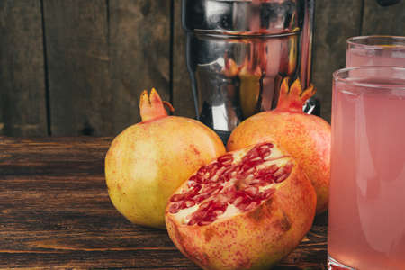 Fresh pomegranate juice on wooden table close upの写真素材