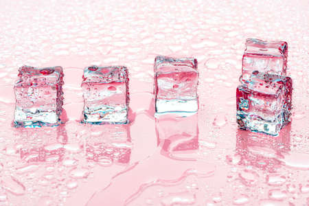 Ice cubes on pink backgroundの写真素材