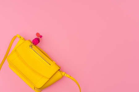 Woman small handbag clutch on a bright pink backgroundの写真素材
