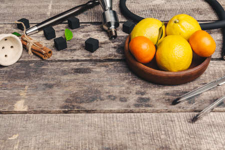 Parts of hookah and fruits on wooden backgroundの写真素材