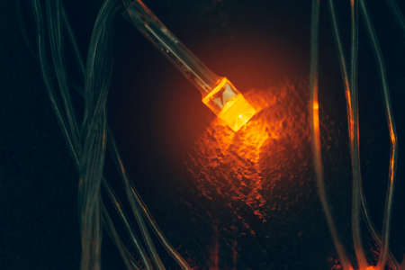 Illuminated garland close up on dark backgroundの写真素材