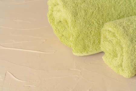 Pile of clean new towels against grey wallの写真素材