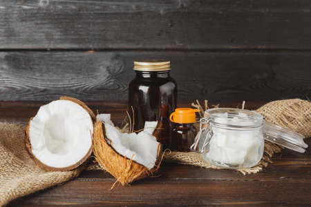 Broken coconut on a dark aged wooden table close upの写真素材