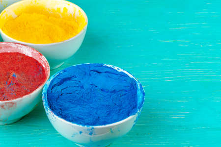 Bows of colorful Holi power close up on floorの写真素材