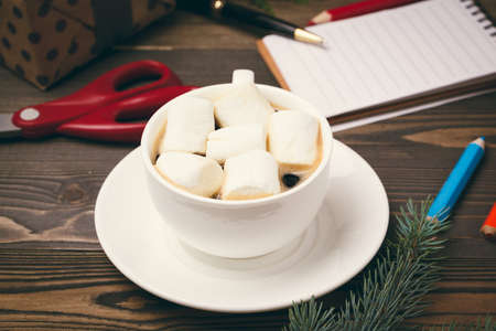 Cup of hot chocolate with marshmellow on wooden backgroundの写真素材