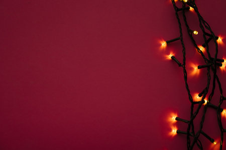 Illuminated garland lights on bright pink backgroundの写真素材
