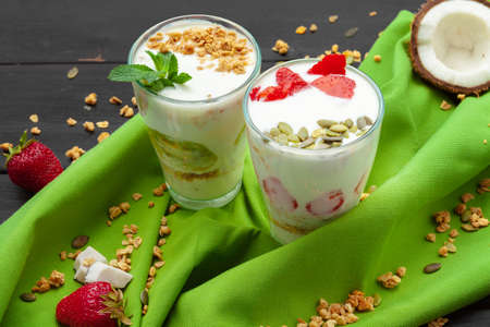 Home-made Yoghurt with granola, fruit and coconut top view on wooden backgroundの写真素材