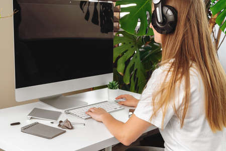 Businesswoman using her computer at an office or at home