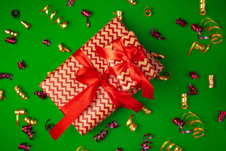 Top view of wrapped present on a green festive background