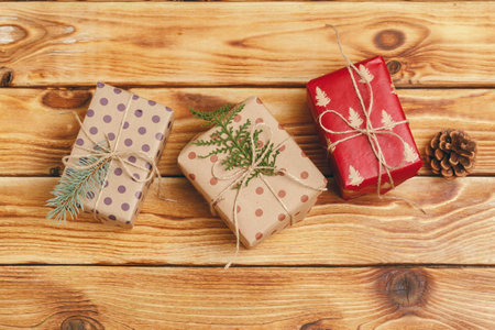 Small christmas gifts on wooden background, view from above