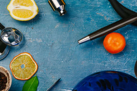 Parts of hookah and fruits on wooden background