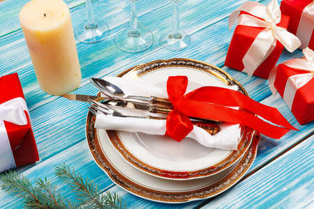 Beautiful red Christmas table setting with decorations close up