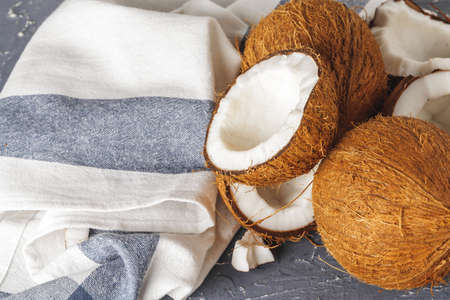 Pile of broken coconuts on ripped grey backgroundの写真素材