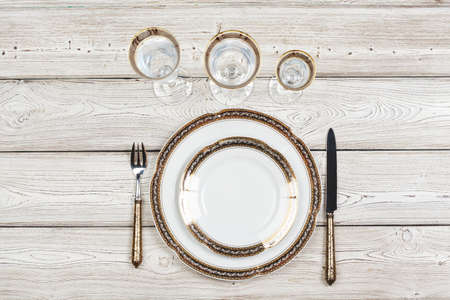Top view of a beautiful table setting on white wooden background