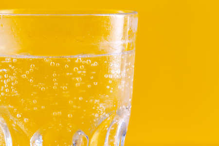 Glass of water on yellow background. Healthy lifestyle