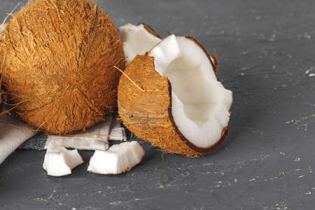 Pile of broken coconuts on ripped grey backgroundの写真素材