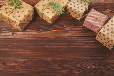 Stylish decorated christmas gifts over brown wooden backgroundの写真素材