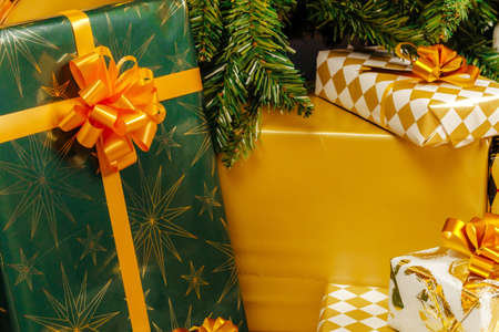 Pile of wrapped green and gold presents for Christmas