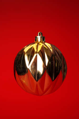 Levitating in air christmas bauble over red background. Christmas cardの写真素材