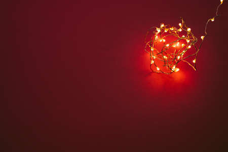 Illuminated garland lights on bright pink backgroundの写真素材