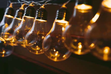 Garland of light bulb lamps in the darkの写真素材