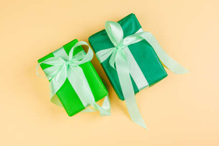 Decorated colored present on yellow background flatlayの写真素材