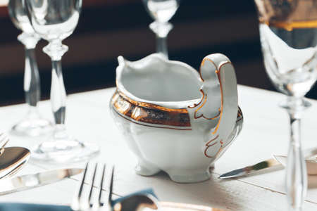 Close up shot of table setting for fine dining with cutlery and glasswareの写真素材