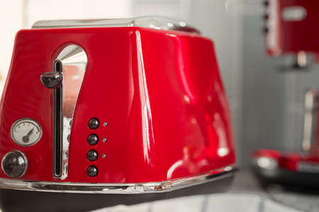 Kitchen shelf with red utensils and dishwareの写真素材