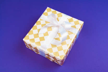 Gift box on purple background top viewの写真素材