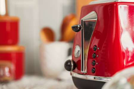 Kitchen shelf with red utensils and dishwareの写真素材
