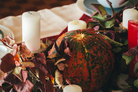 Fall thanksgiving decor with candle and pumpkins close upの写真素材
