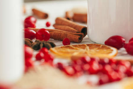 Berries and spices for mulled wine cooking close up on kitchen tableの写真素材