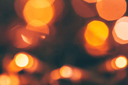 Abstract Gold bokeh sparkle on dark backgroundの写真素材