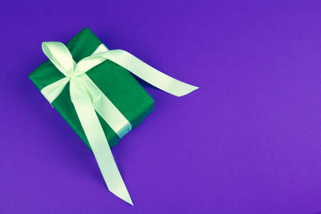 Gift box on purple background top viewの写真素材