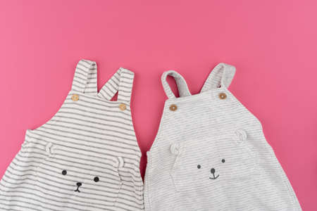 baby clothes on pink background top viewの写真素材