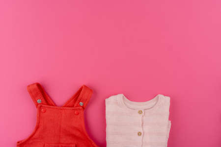 baby clothes on pink background top viewの写真素材