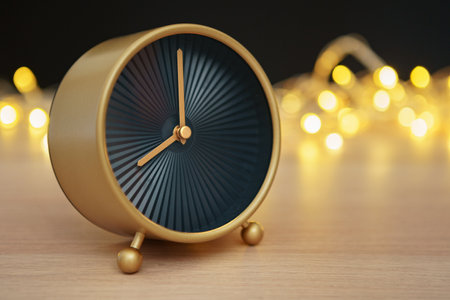 Close up of retro alarm clock on blurred Christmas background with bokehの写真素材