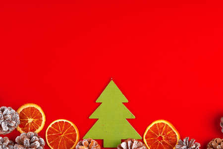 Christmas composition on red background with pine conesの写真素材
