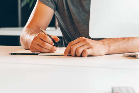 Unrecognizable man working in a modern officeの写真素材