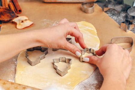 female hands making cookies from fresh dough at homeの写真素材