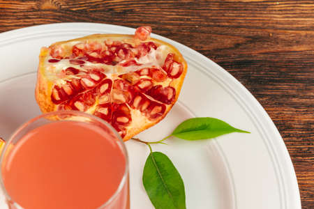 Cut pomegranate fruit on a wooden boardの写真素材